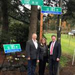 Courtesy photo                                Don and Barbara Adams, the parents of First Lieutenant Michael R. Adams, join King County Councilmember Reagan Dunn under the street sign in the Fairwood unveiled in honor of their son.