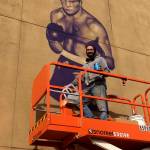 Courtesy photo                                Artist Will Schlough works on a mural of hometown hero Boone Boom Boom Kirkman. The mural will be celebrated Wednesday, Nov. 21 from 5 to 7 p.m. along the wall of La Hacienda Santa Fe on South 3rd Street.