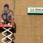 Courtesy photo                                Artist Will Schlough works on a mural of hometown hero Boone Boom Boom Kirkman. The mural will be celebrated Wednesday, Nov. 21 from 5 to 7 p.m. along the wall of La Hacienda Santa Fe on South 3rd Street.