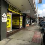 Garland Jewelers has sat in the main stretch of downtown over 60 years. As it closes this month, big yellow banners indicate the end of an era. Photo by Haley Ausbun.