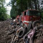 An old Skykomish Fire Engine sits amongst rubble. The pathway it sits on is riddled with tires and broken debris from other vehicles, whereas other areas are more clear of broken scrap. Photo by Caean Couto                                <em>Photo originally published <a href="www.rentonreporter.com/news/the-last-days-of-iron-mountain/" target="_blank">here</a></em>