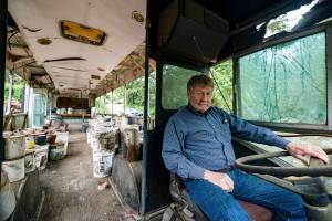 Charles Pillon sits inside one of the several buses on Iron Mountain. Photo by Caean Couto                                <em>Photo originally published <a href="www.rentonreporter.com/news/the-last-days-of-iron-mountain/" target="_blank">here</a></em>