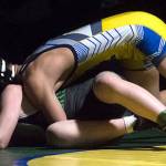 Erik Nguyen earns a takedown in the first period of the 106 pound match. Photo by Kayse Angel