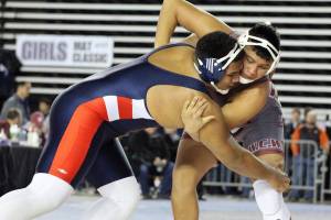 Lindbergh senior Apelu Sellem wrestlers against Terrell Underwood from Toppenish during the quarterfinals of the 2019 Mat Classic. Sellem won the match by decision, advancing to the semifinals round. Photo by Vicki Maddy