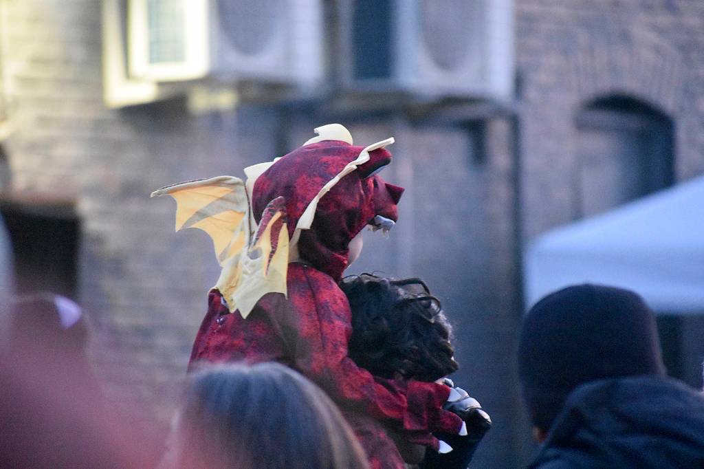 A very young dragon waits for the lighting of the much larger rooftop dragon. Photo by Haley Ausbun.