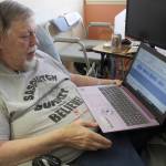 Thom Cantrell, one of the organizers of the upcoming International Conference for Primal People, listens to a 1970s recording, known as the Sierra Sounds, which many Sasquatch believers claim is two Sasquatches having a conversation. One of the recorders, Ron Morehead, will be a speaker at the event on Saturday, April 27. Photo by Ray Miller-Still