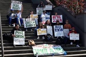 Photo By Haley Ausbun. About 20 Hazen High School students walked out of classes Friday, April 26, and marched to Renton City Hall. The students sat on the steps with their signs, and also went into the building to ask for a sit-down meeting with administrators.