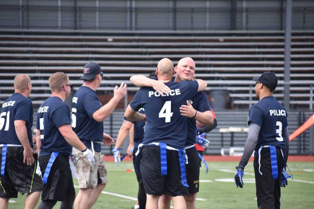 Photo by Haley Ausbun. Renton police celebrate their victory, and another year holding onto the trophy, at the 2019 First Responder Bowl on Saturday, June 8 at Renton Memorial Stadium.