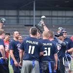 Photo by Haley Ausbun. Renton police celebrate their victory, and another year holding onto the trophy, at the 2019 First Responder Bowl on Saturday, June 8 at Renton Memorial Stadium.