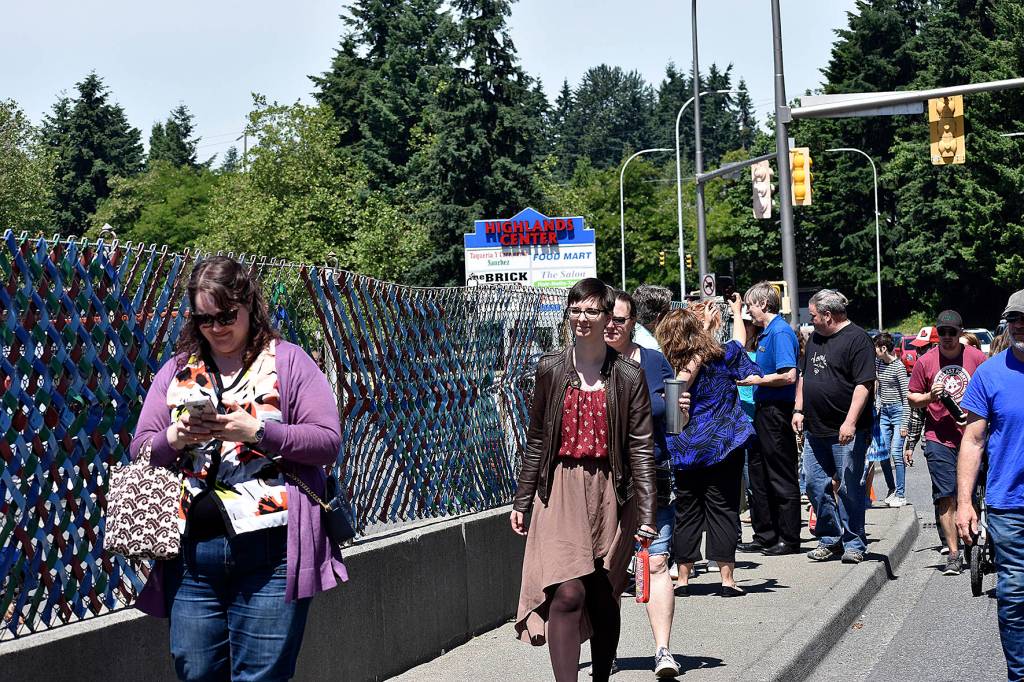 Photo by Haley Ausbun. Attendees of the Sunset fence dedication on June 9, walk along the 800 feet of art.