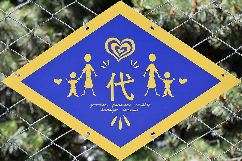 Photo by Haley Ausbun. The plaques featured several words important to the project, including 代 or generations in Chinese. People of different ages contributed to drawing symbols for this project.