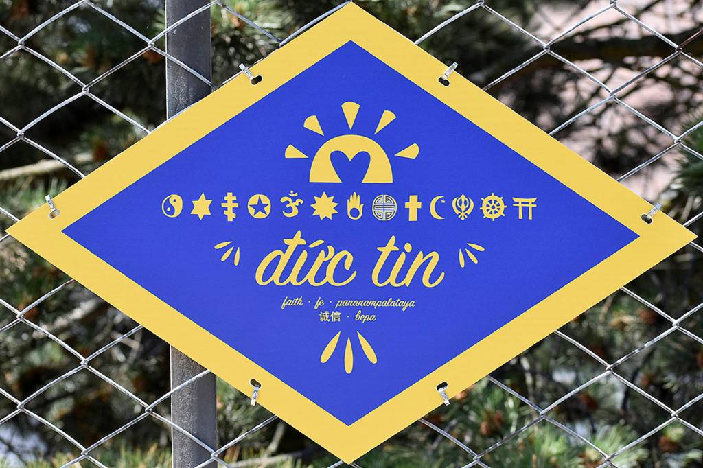 Photo by Haley Ausbun. The plaques featured several words important to the project, including dúc tin, or faith in Vietnamese. The fence runs along the Sunset Community Church.