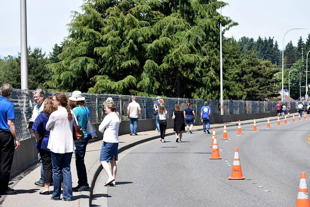Photo by Haley Ausbun. Attendees of the Sunset fence dedication on June 9, walk along the 800 feet of art.