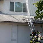 Photo by David Nelson. Firefighters put water through the attic where much of the fire ended. No firefighters were injured while battling the fire.