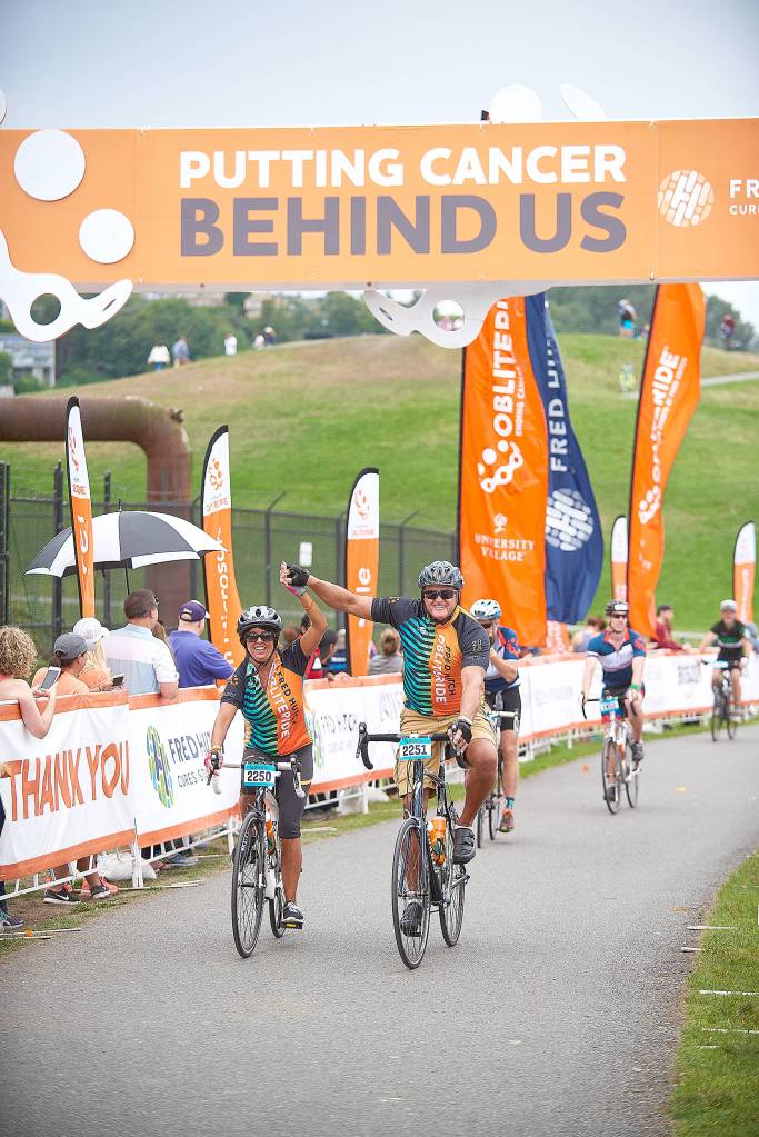Photo courtesy of Fred Hutch Obliteride                                Two riders cross the finish line at the 2018 Obliteride event.