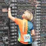 A Obliteride event participant writes the name of someone they love who was affected by cancer, which is why those choose to raise funds for Fred Hutchs cancer research. Photo courtesy of Fred Hutch Obliteride.