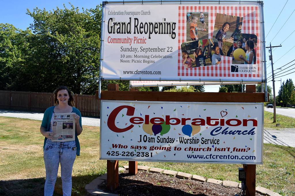 Photo by Haley Ausbun. Pastor Amy Lubienski, standing with a copy of a 2008 Renton Reporter story on her father, who was Pastor of Celebration Foursquare Church until his death in 2017.