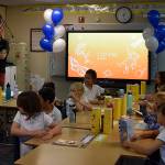 Photo by Haley Ausbun. Faith-Maria, a third grader at St. Anthony Elementary School in Renton and Leukemia survivor, asked Make-a-Wish to share her wish with her school, which resulted in two new smart boards. Students got to try them out at the unveiling, Sept. 12.