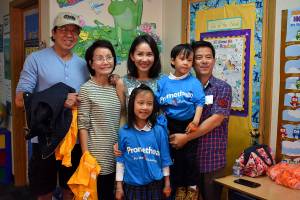 Photo by Haley Ausbun. Faith-Maria, a third grader at St. Anthony Elementary School in Renton, asked Make-a-Wish to share her wish with her school, which resulted in two new smart boards. Faith-Maria with her family at the unveiling, Sept. 12.