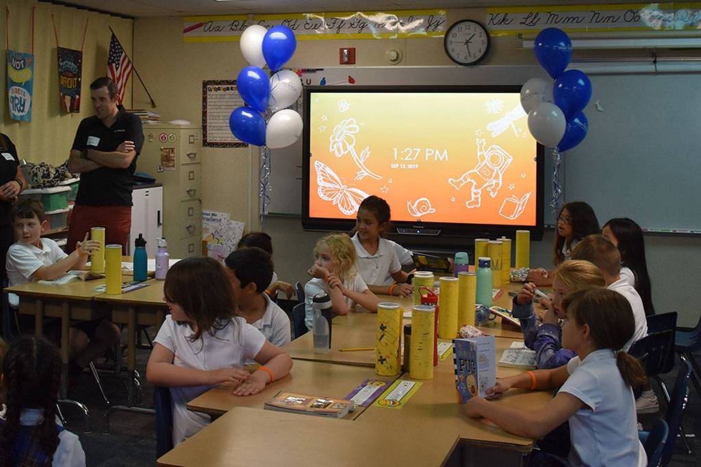 Photo by Haley Ausbun. Faith-Maria, a third grader at St. Anthony Elementary School in Renton and Leukemia survivor, asked Make-a-Wish to share her wish with her school, which resulted in two new smart boards. Students got to try them out at the unveiling, Sept. 12.