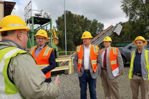 Photo courtesy of King County. From left facing to right, Renton City Councilmember Armondo Pavone, King County Councilmember Reagan Dunn, Renton Public Works Administrator Gregg Zimmerman, and Renton Public Works staff member Joe Farah listen to a briefing on work at the Black River Pump Station during a recent tour.