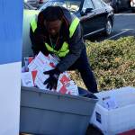 Photo by Haley Ausbun. Election Day in Renton, Nov. 5 2019. Election Office staff empty the bin at the Renton Highlands ballot box.