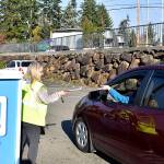 Photo by Haley Ausbun. Election Day in Renton, Nov. 5 2019. Election Office staff take a ballot from a drive-by voter.