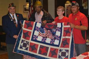 Courtesy of VFW Post 9430                                Left to right: VFW Department of Washington Jr. Vice Commander Chad Hassebroek, Buffalo Soldier, life member of Skyway VFW Post 9430 and current post Guard Clyde Robinson, post Auxiliary President Cheryl Scheeler and post Cmdr. Larry Weldon.