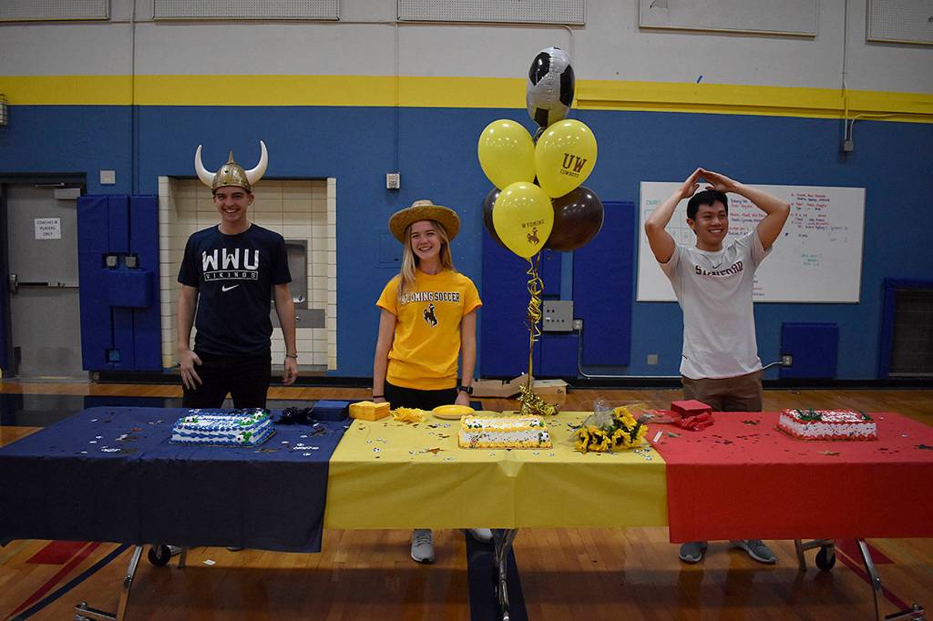 Photo by Haley Ausbun. Left to right: Eric Bunnell, Rae Gerking and Ethan Dang. These Hazen High School students signed on to be college athletes on Nov. 13 at a ceremony at Hazen High School.