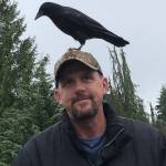 Renton resident Joe Copenhaver and his pet crow, T-Rex, share a moment Nov. 10. Photo by Andy Hobbs