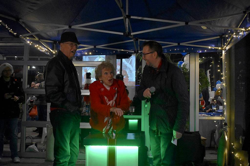 Photo by Haley Ausbun. Left to right: Bill Moss, Fay Moss, Renton residents and longtime contributors to the community, and Mayor-elect Armondo Pavone, pulled the switch to light to the downtown tree, Saturday, Nov. 30 at Piazza Park.