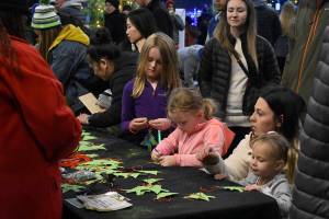 Photo by Haley Ausbun. Booths for kids to make Christmas tree decorations were one of the highlights at the pop-up market during the downtown tree lighting in Renton. Saturday, Nov. 30 at the Renton Pavilion Events Center.