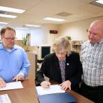 Photo courtesy of city of Renton. City Clerk Jason Seth with newly-elected Councilmember Valerie OHalloran as she completes the swearing-in process with husband and planning commissioner Michael. OHalloran will finish out the year on city council filling the empty seat, before starting her four-year term in January.