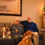 Photo by Haley Ausbun. Cindy Kraayeveld and her husband, Dave Kraayeveld, with their two dogs. Dave survived cardiac arrest thanks to first responders and a brave post office manager.