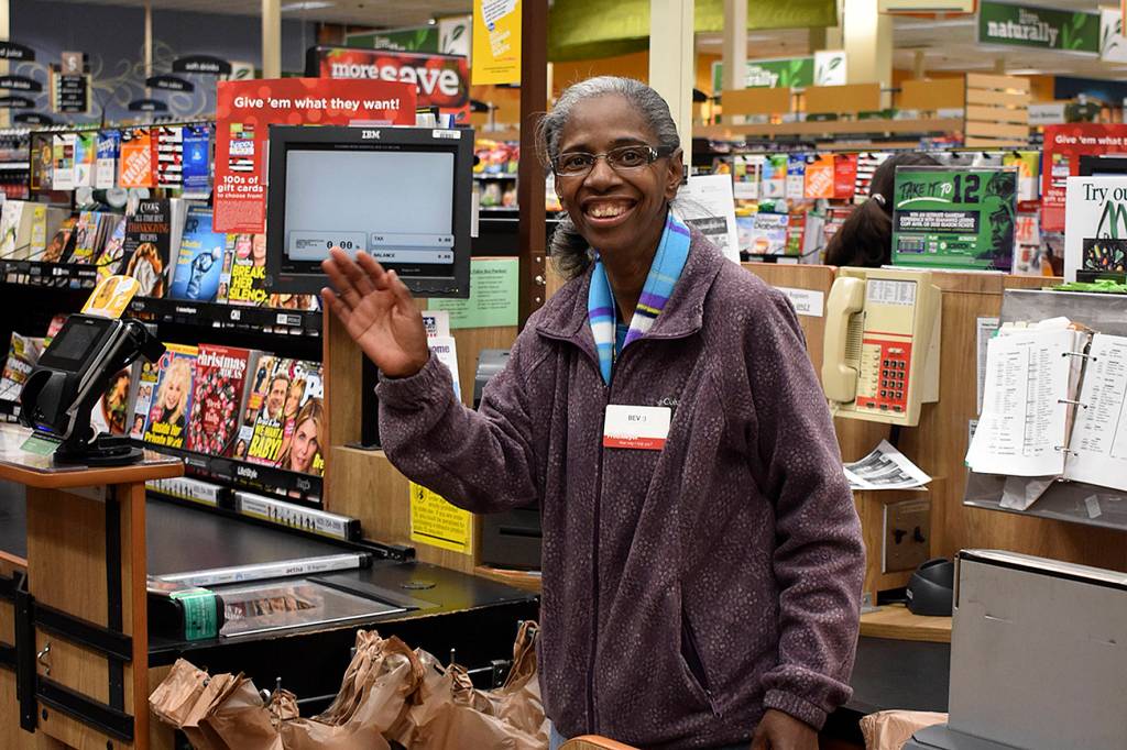 Photo by Haley Ausbun. Beverly Bev McQueen, beloved cashier at the Benson Fred Meyer, at her checkstand, number nine.