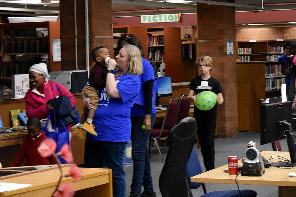 Photo by Haley Ausbun. In the Lindbergh High School library, United Way volunteers watched kids and small children while their parents talked to housing assistance providers at the Family Resource Exchange event on Martin Luther King Jr. Day, Jan. 20.