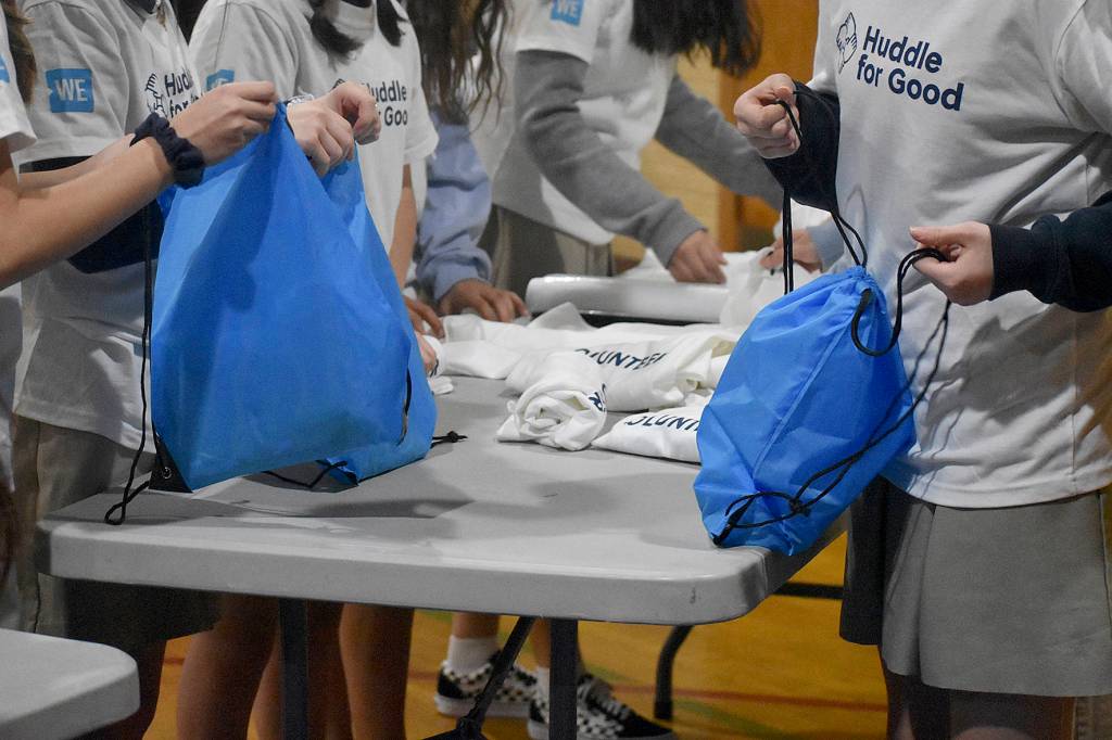 Photo by Haley Ausbun. On Jan.22 about 60 St. Anthonys students put together gift bags with school supplies for their sister school in Haiti, with the help of the WE and NFL Huddle for Good initiative. The schools connected after the devastating earthquake in Haiti killed a young missionary connected to the parish in Renton.