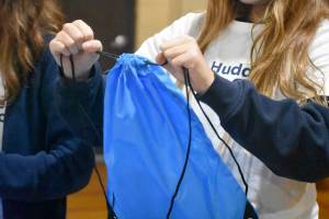 Photo by Haley Ausbun. On Jan.22 about 60 St. Anthonys students put together gift bags with school supplies for their sister school in Haiti, with the help of the WE and NFL Huddle for Good initiative. The schools connected after the devastating earthquake in Haiti killed a young missionary connected to the parish in Renton.