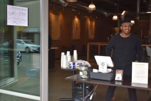 Photo by Haley Ausbun                                Boon Boona Coffee in downtown Renton is well-known for its large cafe space, but owner Efrem Fesaha has found a creative way to keep people to to-go orders only, putting a table right at the door. The order from the Governor hasnt been easy for small businesses in Renton, and many are just taking it day to day and hoping for financial relief from local and regional leaders.