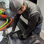 Ryan Schwalb punches holes in a transparent film to attach the face shield to a mask frame, creating personal protection equipment for frontline healthcare workers. Photo courtesy of Ryan Schwalb