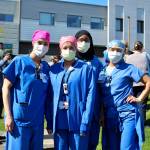 St. Francis Hospital employees pose for a photo, before laughing about smiling behind their masks. Olivia Sullivan/staff photo