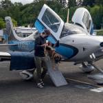 After a three-hour flight, co-pilot Everett King helps rescue pup Andy get off the plane, May 23, 2020, at Renton Municipal Airport. Photo by Andre Osorio/For the Renton Reporter