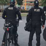 Officers keep watch on a large group that assembled Sunday night, May 31, near the LA Fitness in Tukwila. The group later began looting businesses. COURTESY PHOTO, Tukwila Police