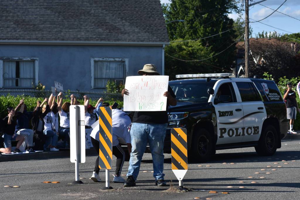 Protesters gathered at Renton City Hall, Monday, June 1. This protesters sign reads: Can I live to be 21 please? Photo by Haley Ausbun.