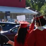 Renton High School seniors came to the Renton protest still in their cap and gown from the drive-thru graduation ceremony, Monday, June 1. Photo by Haley Ausbun.