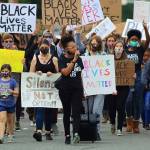 JoJo Wu Holiday leads a group of protesters down Williams Ave South on Friday. Holiday, a member of Leading the Community with Purpose: Intentional Protests, called out the Renton Police Department for its response to an officer-involved shooting at Cheers Bar last June 2019. According to family, Mantry Norris, 20-year-old Renton resident, suffered from mental illness and the mishandling of it led to his death. Photo by David Nelson.