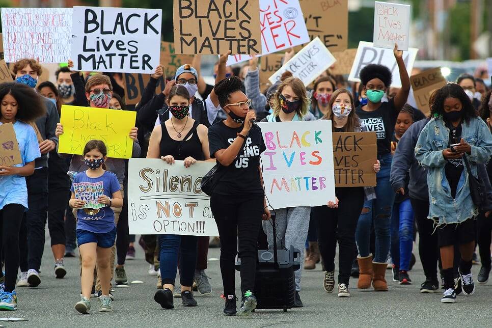 JoJo Wu Holiday leads a group of protesters down Williams Ave South on Friday. Holiday, a member of Leading the Community with Purpose: Intentional Protests, called out the Renton Police Department for its response to an officer-involved shooting at Cheers Bar last June 2019. According to family, Mantry Norris, 20-year-old Renton resident, suffered from mental illness and the mishandling of it led to his death. Photo by David Nelson.