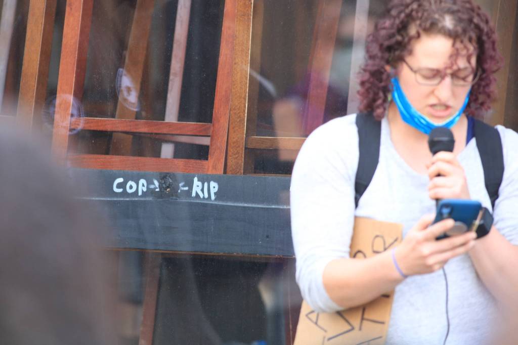 A letter from Mantry Norris mother let it known her son had a mental illness when he was shot and killed by a Renton Police Sergeant nearly a year ago at Cheers Bar. A permanent mark (left) is a bullet hole that went through the table, window and across the street. It was the first officer involved shooting in 10 years. Photo by David Nelson.