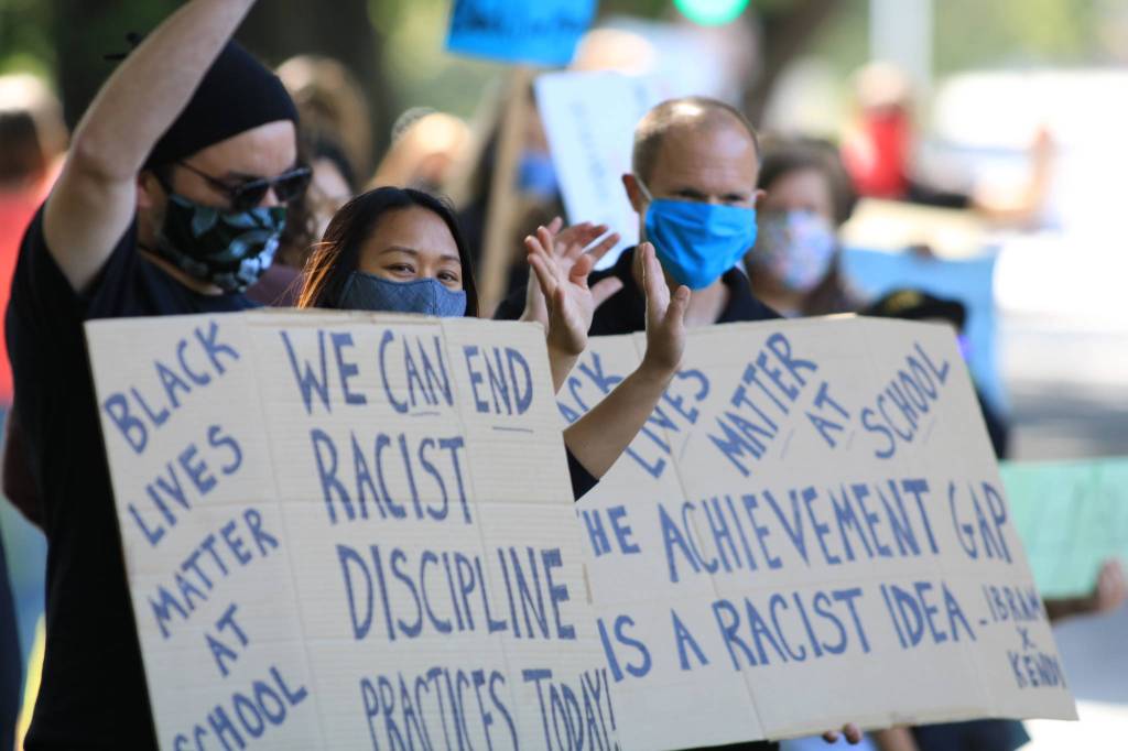 Lindbergh High School teachers hold signs calling for the end of racist discipline practices and the achievement gap. Photo by David Nelson.
