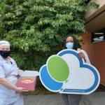 RTC student Rose Milianta, left, delivering a birthday cake to Birthday Dreams Volunteer Coordinator Tiffaney Jones to give to a child in need. Courtesy photo/Renton Technical College